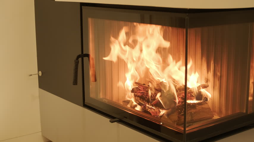 Cozy modern living room with a burning corner fireplace 