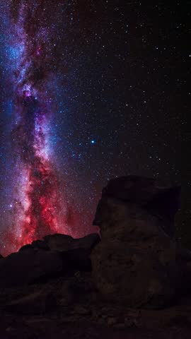 Night landscape, rock under bright colorful milky way galaxy. Space, starry sky time lapse.