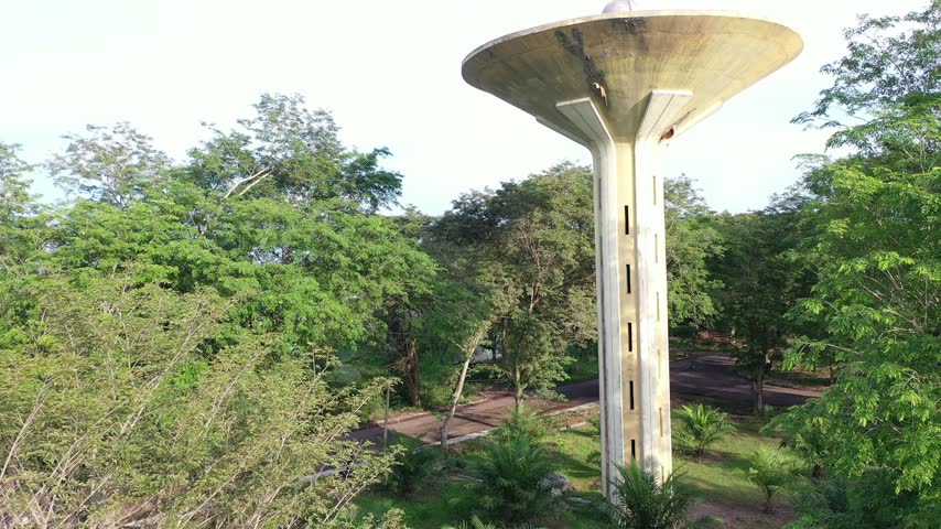 Low Angle View of Water Tower Surrounded by Green Trees