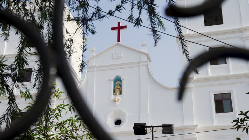 Colonial Era Church Exterior With White Walls And Red Cross