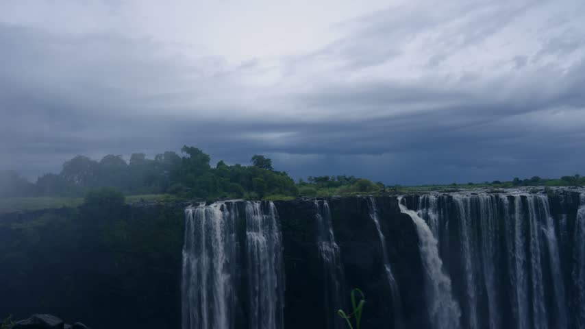 Wide view of the main falls at Victoria Falls in mist.