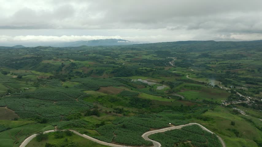 Mountain road between a banana plantation and agricultural land. Mindanao, Philippines.