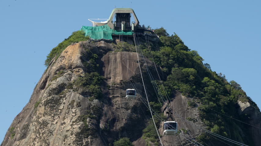 Cable cars passing in opposite directions between Morro da Urca and Sugarloaf Mountain, Rio de Janeiro, Brazil.