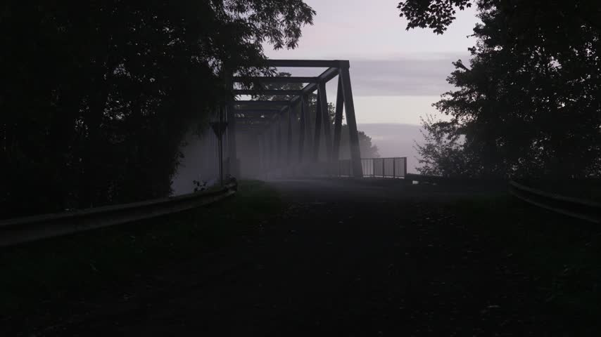 Mist curls around the bridge