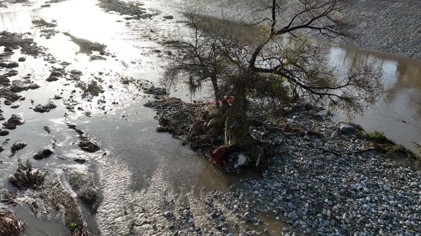 Aerial shot of flood damage and trash in the Los Angeles River after heavy rains.