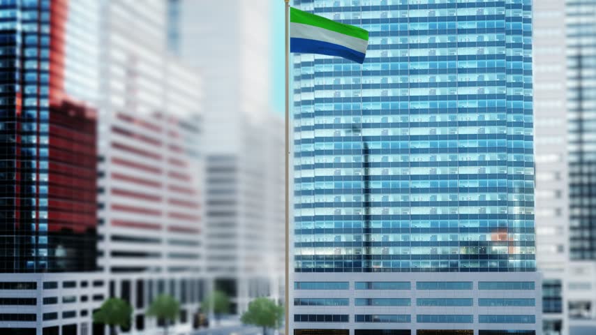 Sierra Leone Flag Waving by Modern Glass Buildings - Daytime