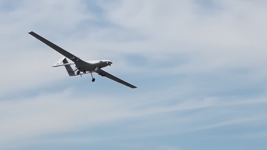 Fixed Wing Drone Flying against Blue Sky.