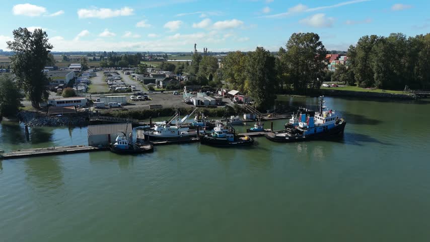 Aerial view of tugboats moored at the river log booms in Richmond, British Columbia, Canada.