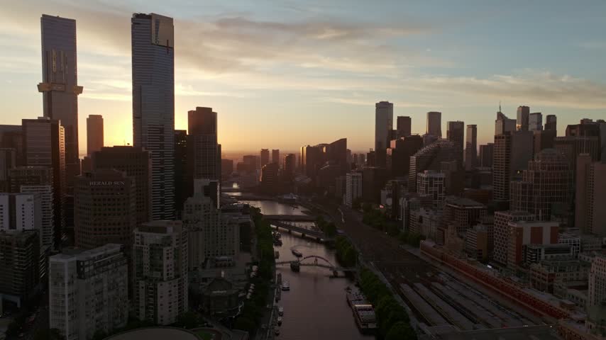 Aerial view of the Southbank skyline and Yarra River during golden hour in Southbank, Victoria, Australia.