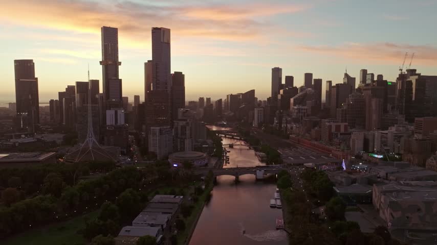 Aerial view of the Southbank skyline and Yarra River during golden hour in Southbank, Victoria, Australia.