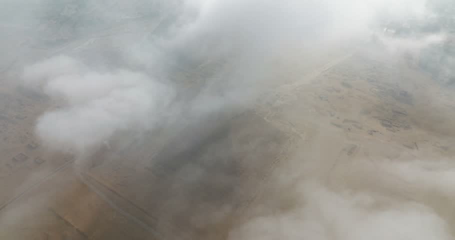 Aerial view of Egyptian pyramids partially obscured by clouds