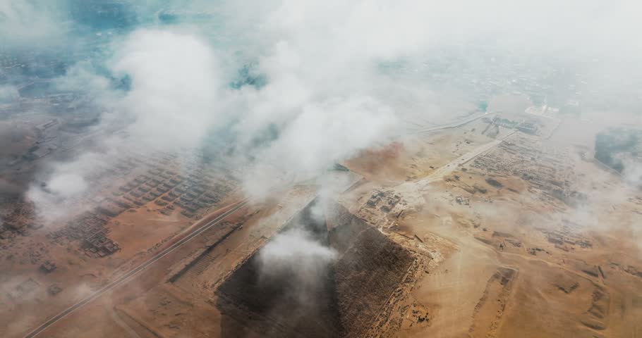 Aerial View of Egyptian Pyramids Amidst Cloudy Skies
