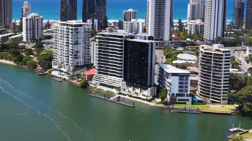 High angle aerial shot of luxury waterfront apartments along the river in Surfers Paradise, Australia.