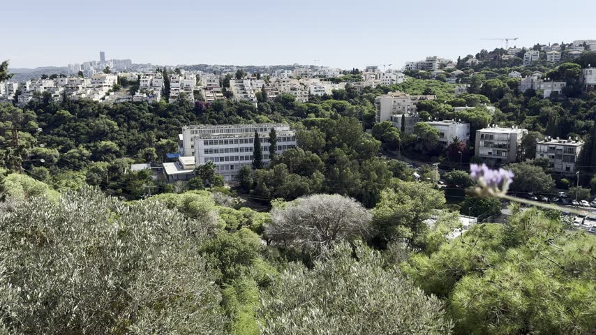 View from a grassy hill overlooking newly developed residential suburbs of Jerusalem, Israel.