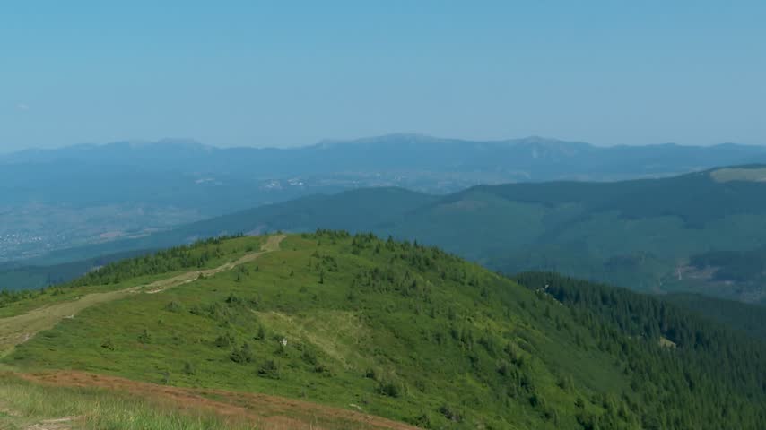 Hiking trail on mountain ridge leading towards Mount Hoverla in Ukrainian Carpathians
