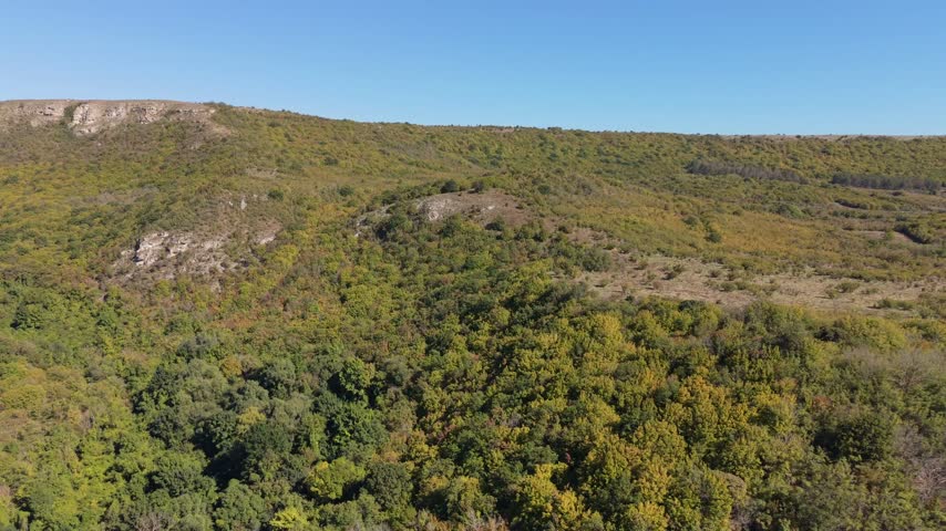 Beautiful drone landscape showing rugged hills, dense bushes, rocky slopes, and wilderness.