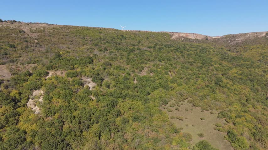 Beautiful aerial landscape showing dry hills, rocky slopes, shrubs, and natural vegetation.