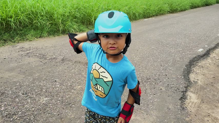 Child in action during Roller Skating With Helmet And Protective Pads Outdoors