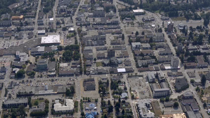 Suburban City With Shopping Centers, Commercial Buildings, And Residential Neighborhoods In Canada. - aerial shot