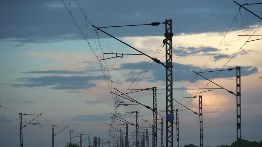 Overhead train wires amidst the autumn sunset