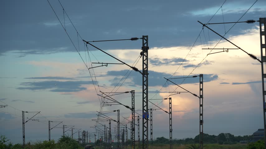 Overhead train wires amidst the autumn sunset
