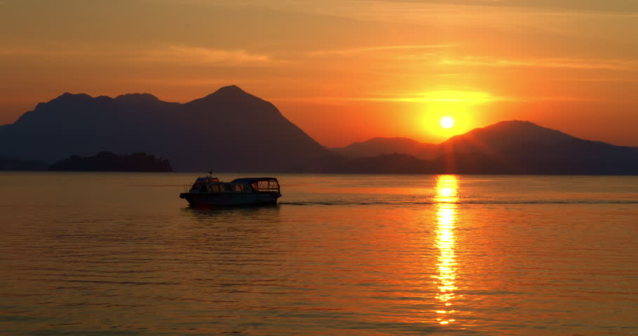 Landscape with a boat at dawn on the lake