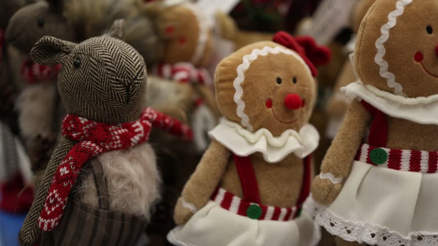 Christmas gingerbread dolls and festive reindeer toys fill a holiday store display creating a cozy seasonal atmosphere with cute decorations for winter gift shopping