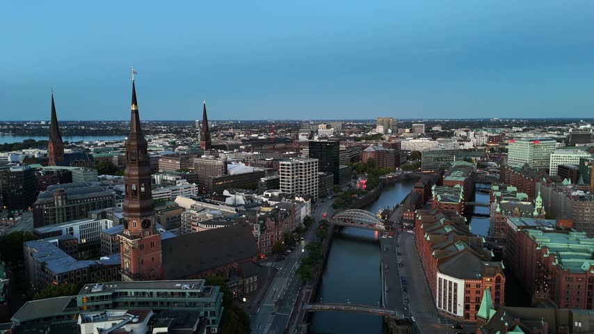 Aerial view of the historic Speicherstadt district with its iconic brick warehouses, canals, and St. Catherine