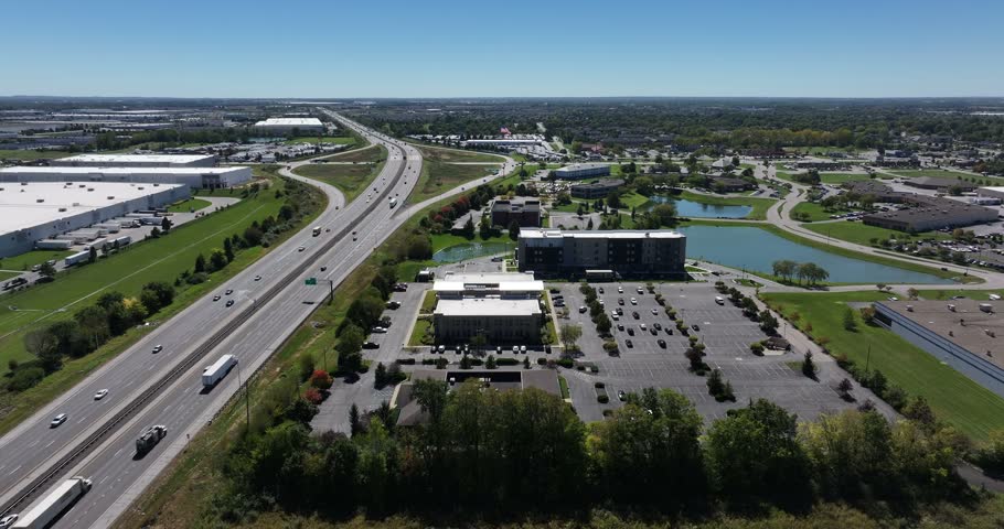 Aerial view of a highway and business park with office buildings, parking lots, and small ponds in Greenwood, Indiana, United States.