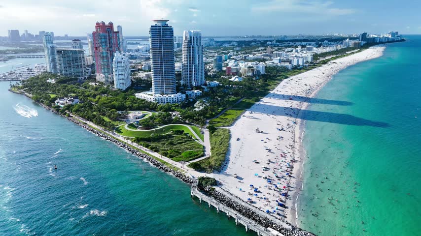 Aerial view of South Beach skyline and coastline with turquoise waters and sandy beach in Miami-Dade County, Florida, United States.