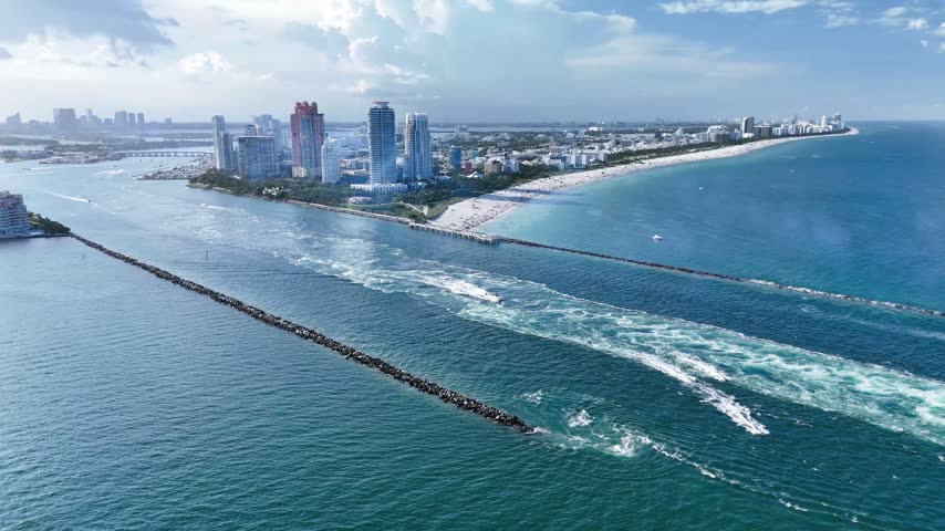 Aerial view of the coastline at South Beach with skyscrapers and the jetty in Miami-Dade County, Florida, United States.