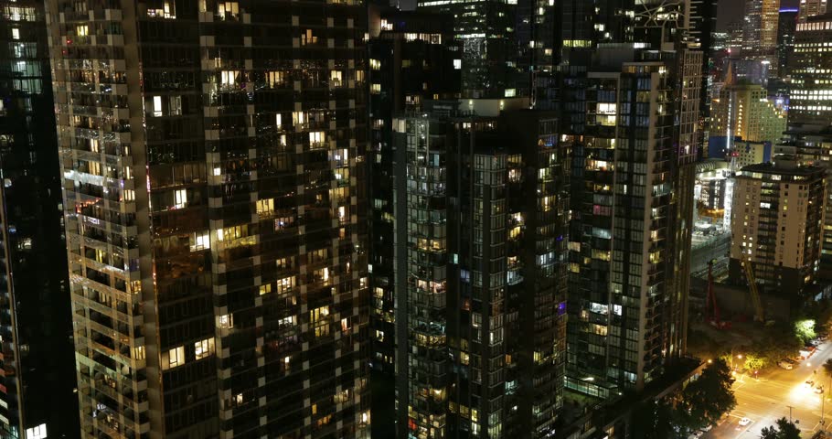 Melbourne apartment towers at night with lit windows timelapse.