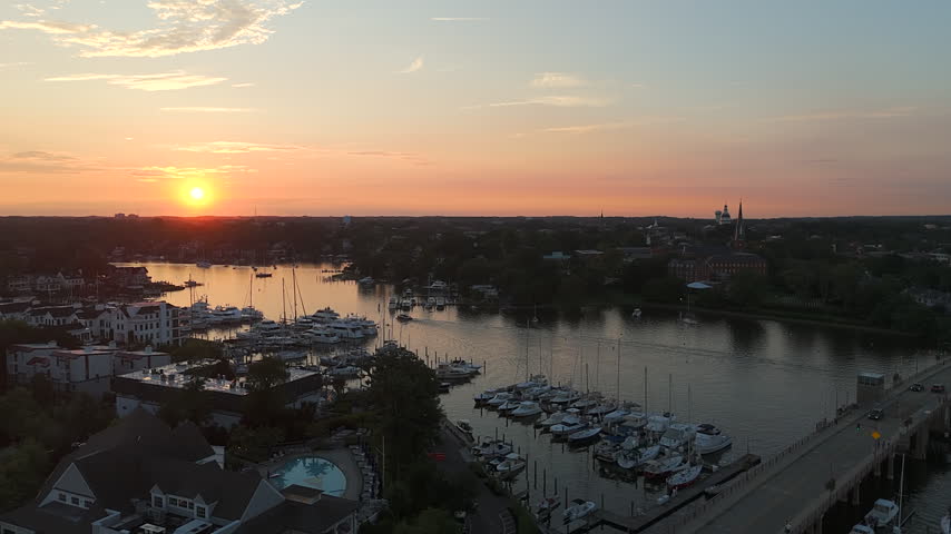 Sun Setting Over Spa Creek, Waterfront Marinas, Bridge, And Annapolis City Skyline In Maryland, USA. - aerial shot