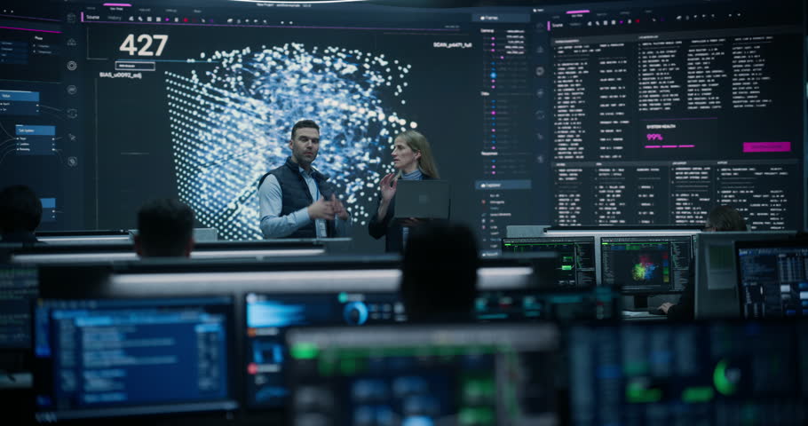 Portrait of a Financial Risk Analyst and an E-commerce Logistics Manager Holding a Laptop, Meeting Briefing on AI Network on Screen in Statistics Monitoring Room Cyber Security.
