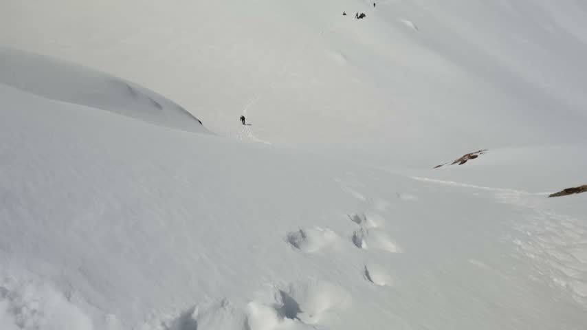 Snow Covered Himalayan Mountain Slope with Trekking Trail and Distant Peaks