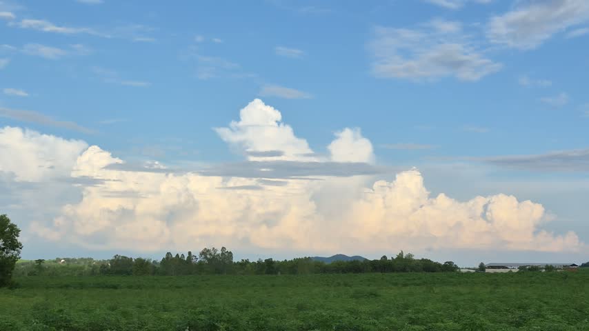 Storm cloud over green field