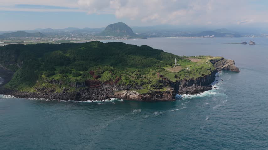 Songaksan Mountain Trail With Rugged Volcanic Coastline Near Seogwipo On Jeju Island, South Korea. Aerial Rotating Shot
