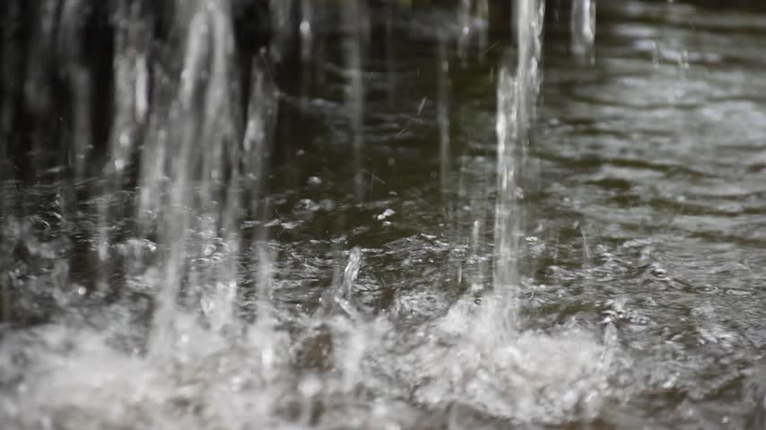 A small waterfall of fresh water dropping from the ledge in the creek.