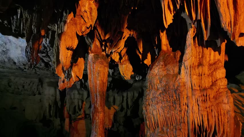 Limestone cave with glowing stalactites and stalagmites