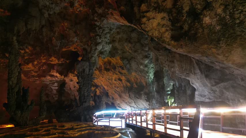 Limestone cave with illuminated rock formations and walkway