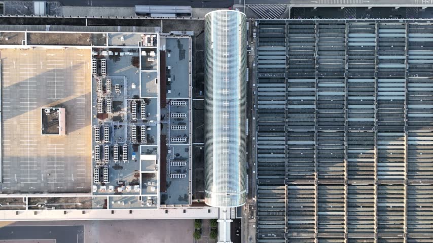 Aerial view of the modern glass terminal building and parking structure at the airport in Frankfurt am Main, Hessen, Germany.
