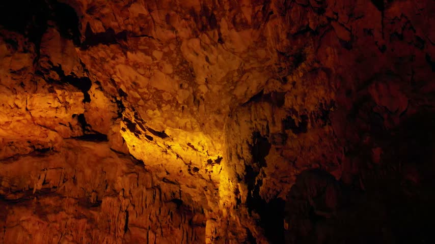 Luminous limestone cave interior with warm lighting