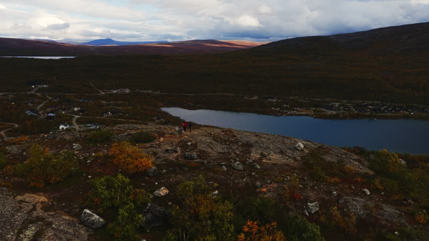 Aerial view of Kilpisjarvi lake surrounded by rocky terrain and autumn foliage in Kilpisjarvi, Lapland, Finland.