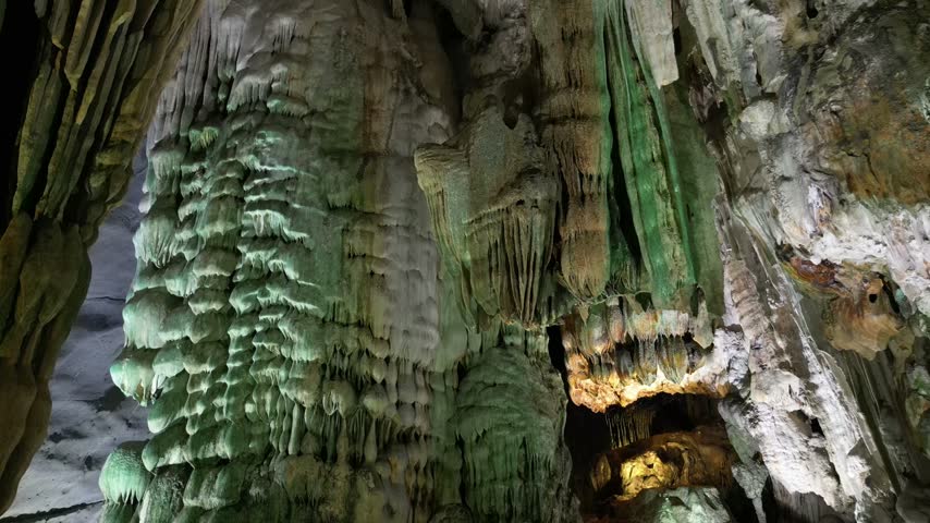 Limestone cave with stalactites and mossy rock formations