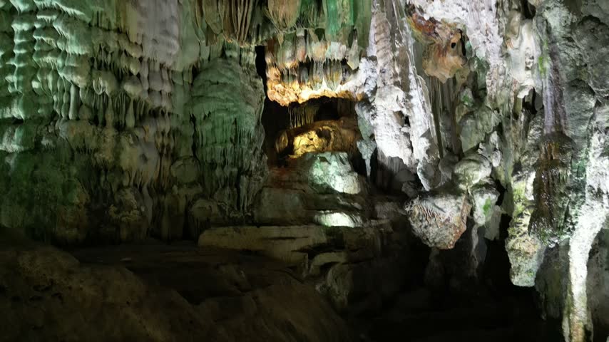 Stunning limestone cave formations with green moss