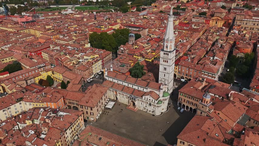 Aerial drone view of Modena Cathedral, Duomo di Modena, in Italy, showcasing its Romanesque architecture, historic rooftops, Piazza Grande, and the heart of Modena old town.