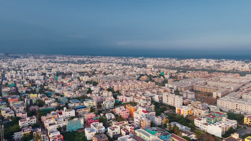 Aerial view of the dense urban cityscape of Chennai with residential buildings and coastal views in Chennai, Tamil Nadu, India.