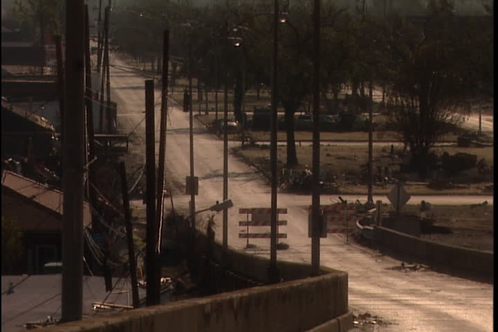 Abandoned neighborhood in New Orleans after Hurricane Katrina (October 2005), camera zooms in to a Road Closed sign.
