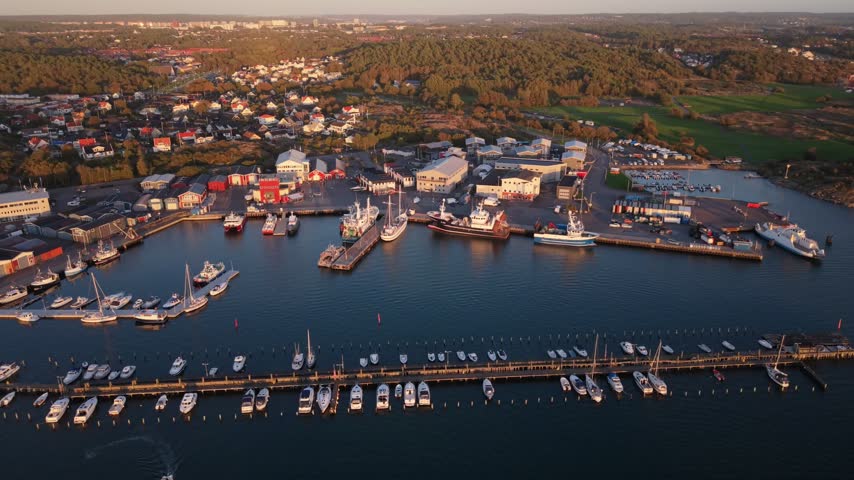 Aerial view of Fiskeback harbor with numerous fishing boats and yachts docked along the piers in Gothenburg, Vastra Gotaland County, Sweden.