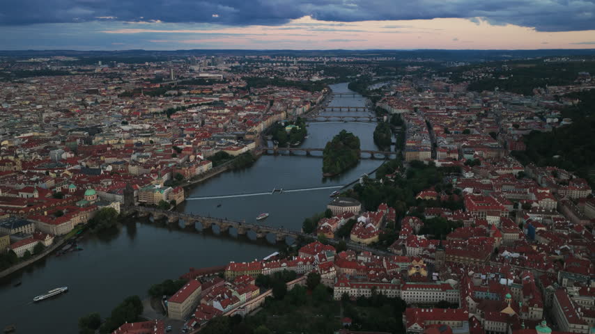 Historic Prague Skyline, Bridges, And River Islands During Sundown In Czech Republic. - aerial shot